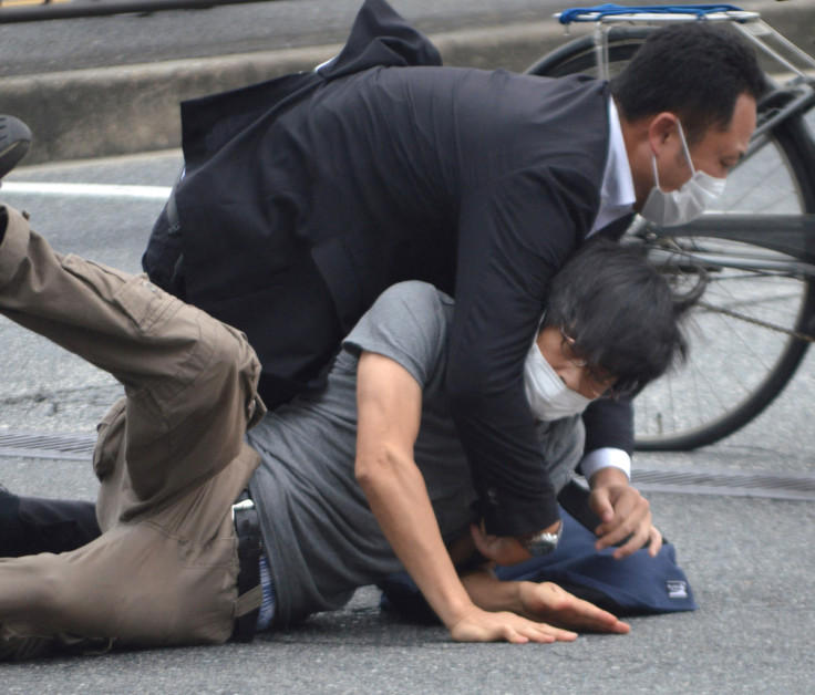 A man, believed to be a suspect shooting Japanese Prime Minister Shinzo Abe is held by police officers at Yamato Saidaiji Station in Nara