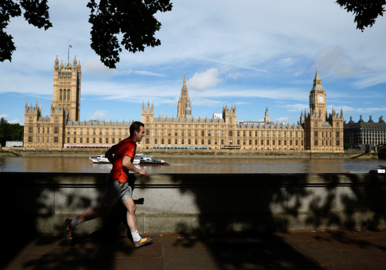 A man runs along the Thames in front the Houses of Parliament in London