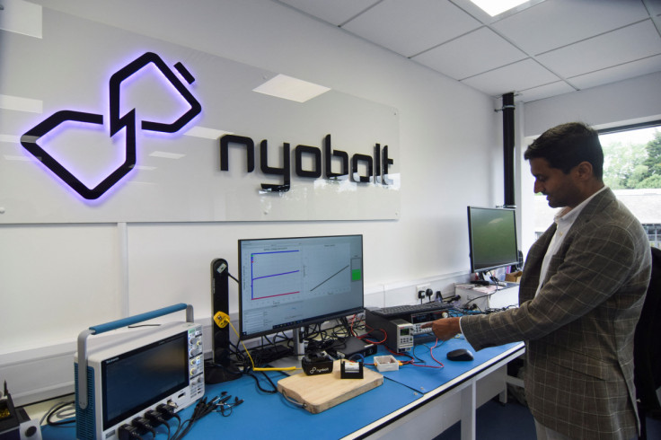CEO of fast-charging battery startup Nyobolt Sai Shivareddy demonstrates a pack of batteries at the company’s headquarters in Cambridge