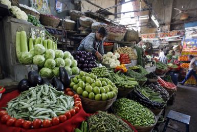 A vegetable seller waits for customers at a market in Ahmedabad