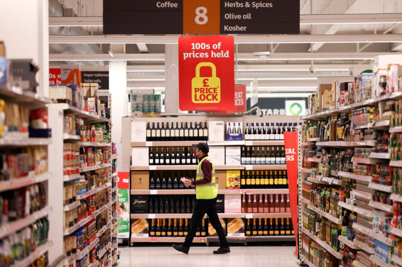 A employee walks inside a Sainsbury’s supermarket in Richmond, west London