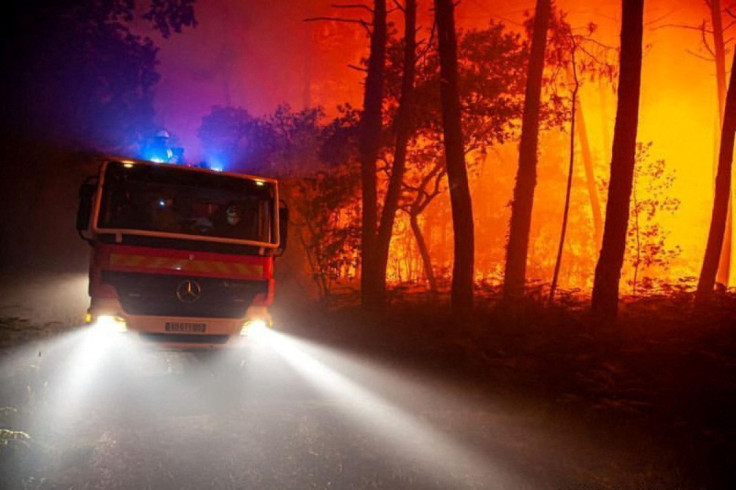 A view of trees burning amid a wildfire near Landiras