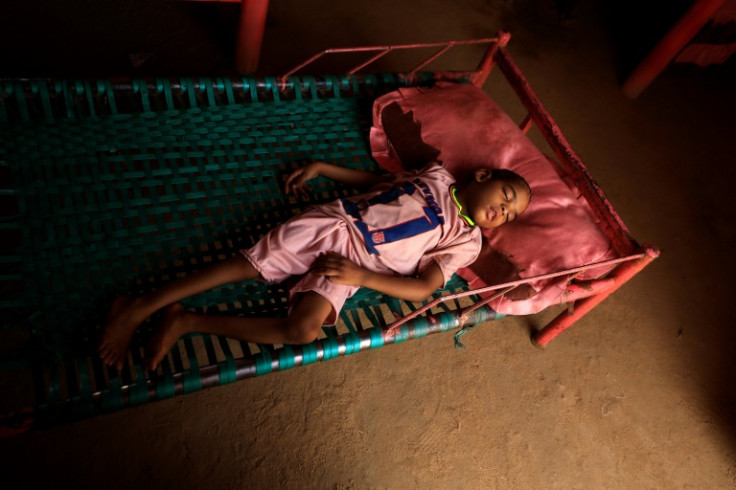 Talab, the youngest child of Awadya Ahmed, lies on a bed in the village of Banat in River Nile state, north of the Sudanese capital Khartoum. She says Talab was born after mining residues spread in the area