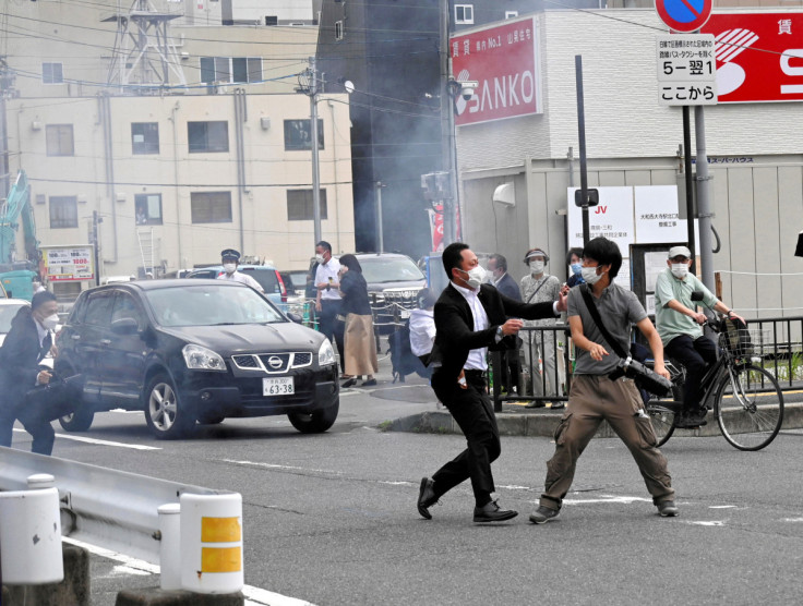 A police officer seizes a man, believed to have shot former Japanese Prime Minister Shinzo Abe, in Nara