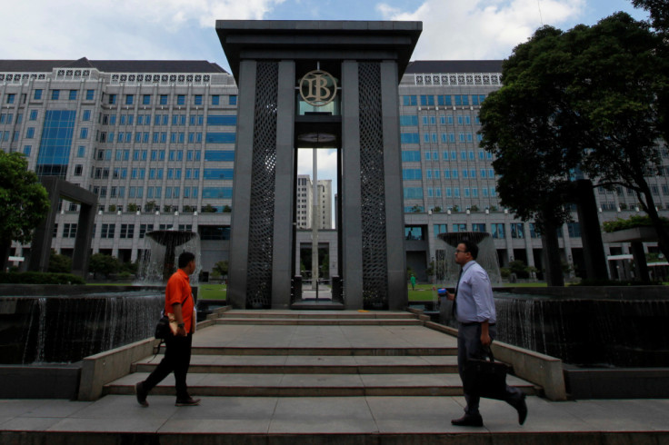 People walks near the fountain of Indonesia's central bank, Bank Indonesia, in Jakarta