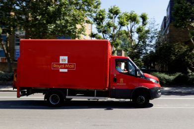 A delivery vehicle drives along a road near Mount Pleasant, in London