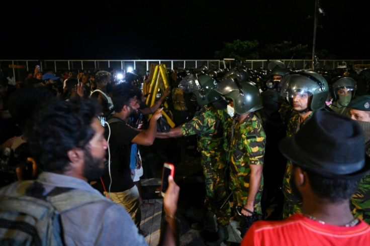 Sri Lankan soldiers and police confront protesters in the early hours of Friday in Colombo