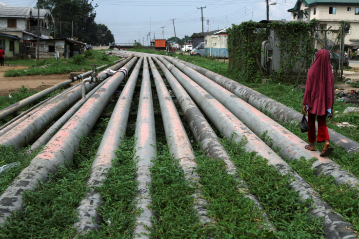 A girl walks on a gas pipeline running through Okrika community near Nigeria's oil hub city of Port Harcourt