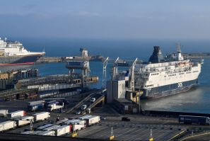 Vehicles disembark from a cross-channel ferry in the Port of Dover