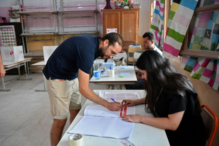 A citizen confirms his details ahead of casting his vote