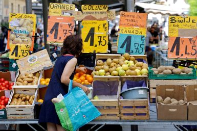 Price tags are seen as a woman shops at a local market in Nice