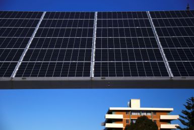 A solar array, a linked collection of solar panels, can be seen in front of a residential apartment block in the Sydney suburb of Chatswood in Australia