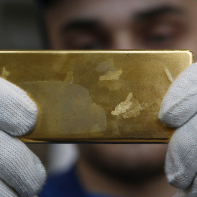 Employee shows gold bar at Prioksky Non-Ferrous Metals Plant in Kasimov