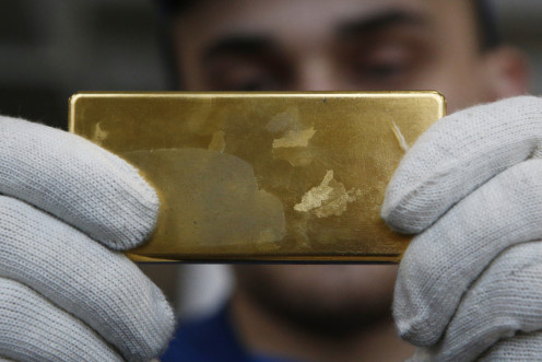Employee shows gold bar at Prioksky Non-Ferrous Metals Plant in Kasimov