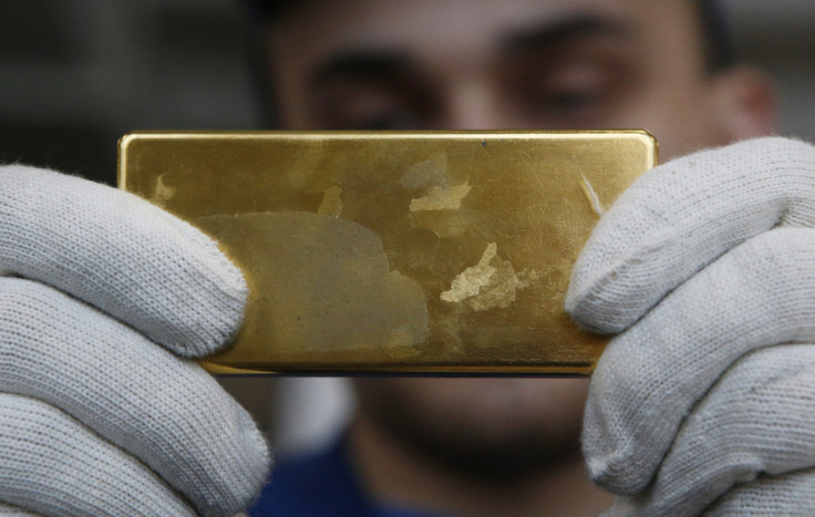 Employee shows gold bar at Prioksky Non-Ferrous Metals Plant in Kasimov