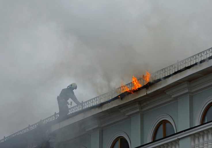 Firefighters extinguish a fire on the roof of a railway station in Donetsk