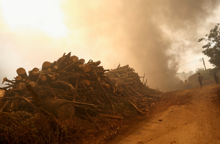 People evacuate after a wild fire, in Leiria