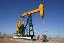FILE PHOTO - A oil field worker works at a pump jack in PetroChina's Daqing oil field in China's northeastern Heilongjiang province