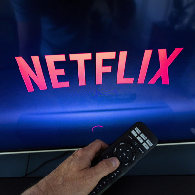 A Netflix logo is shown on a TV screen in this illustration