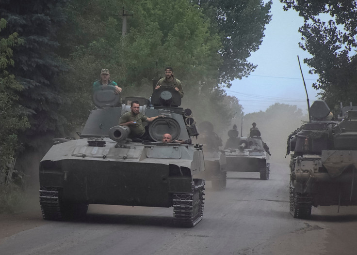 Ukrainian servicemen ride self-propelled howitzers not far from front line in Donetsk region