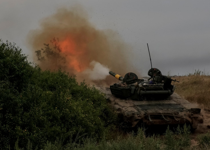 Ukrainian servicemen fire toward Russian troops with a tank at a position in Donetsk region