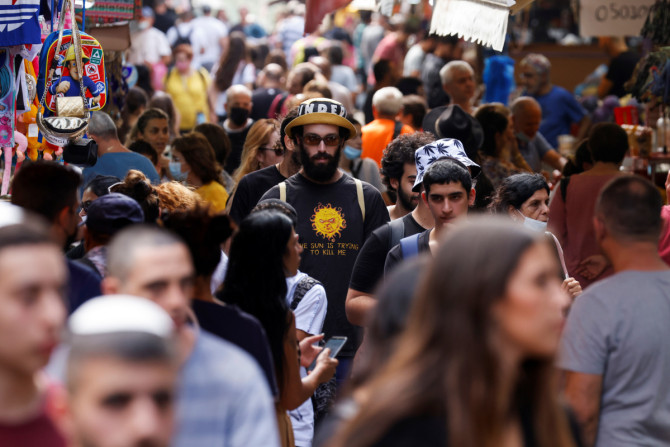 Shoppers explore the Carmel Market as coronavirus disease (COVID-19) restrictions ease in Tel Aviv