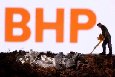 Small toy figure and mineral imitation are seen in front of the BHP logo in this illustration