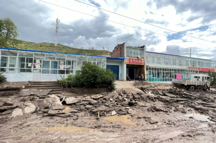 A road is damaged after a flash flooding caused by a sudden downpour triggered mudslides in Datong county, Xining city, in China's northwestern Qinghai province on August 18