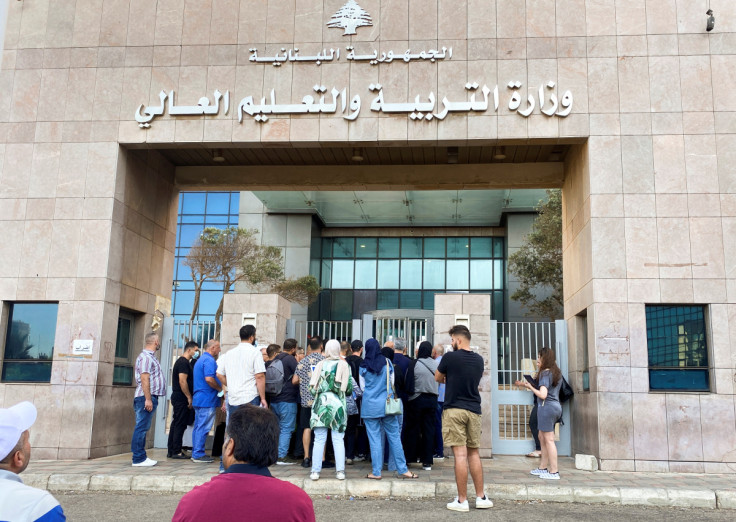 People gather at the entrance of the Ministry of Education and Higher Education during intermittent workers strike in Beirut