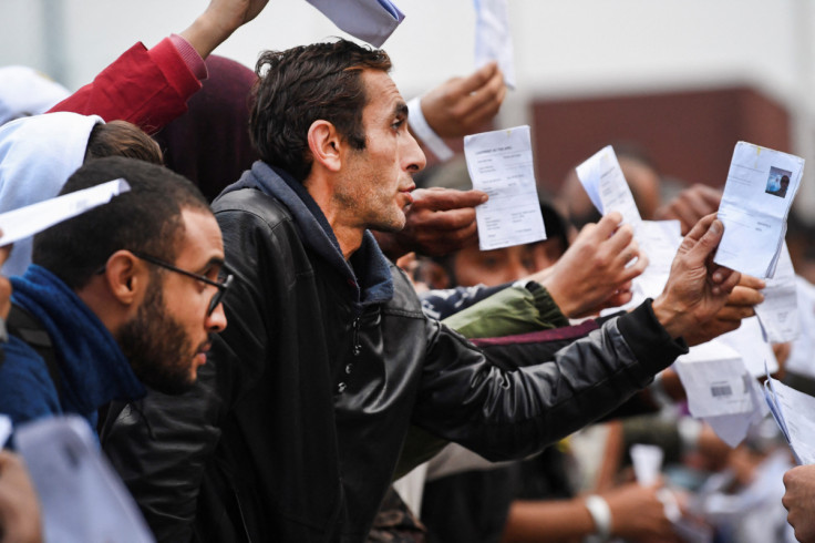 Refugees show their papers at the main reception centre for asylum seekers, in Ter Apel