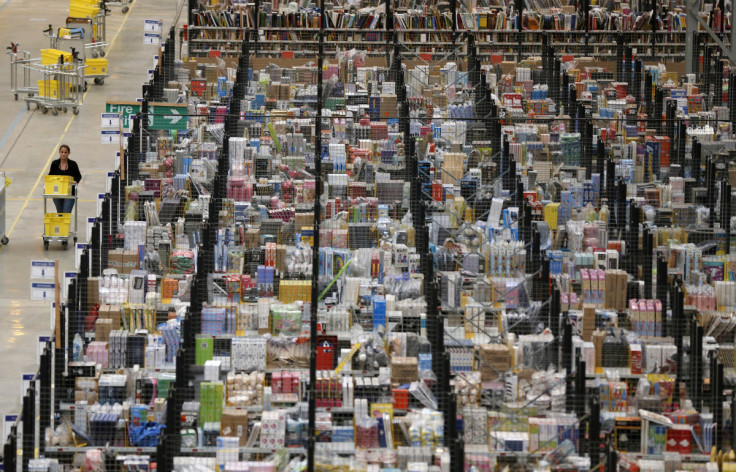 A member of staff pushes a trolley as she collects orders at the Amazon fulfilment centre in Peterborough