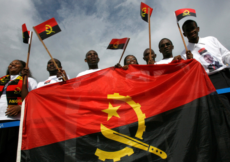 Resident students from Angola wave national flags at Havana's Jose Marti airport