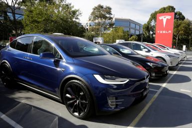 A Tesla Model X car (front) and Model S (2nd L) are photographed at a Tesla electric car dealership in Sydney