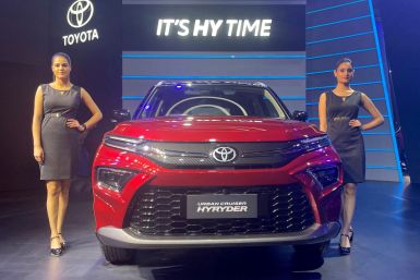 Models pose at the unveiling of Toyota's new hybrid SUV Urban Cruiser Hyryder in New Delhi