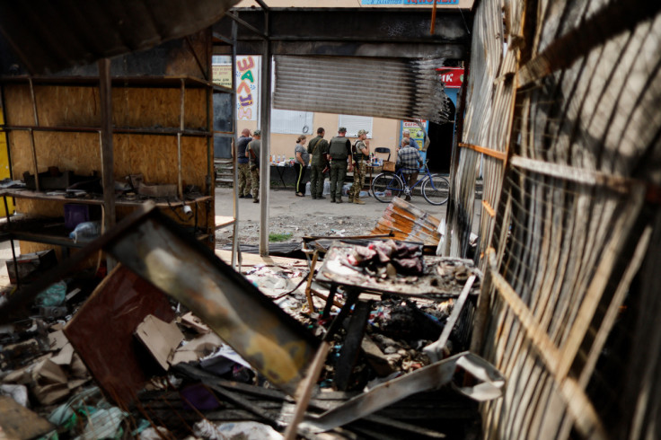 Ukrainian military officers and civilians shop at a street market in Bakhmut