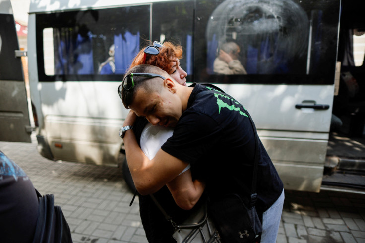 Son hugs his mom, during the evacuation from war-affected areas in eastern Ukraine, in Bakhmut