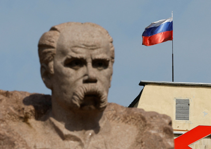 The Russian flag flies on the top of a building in Enerhodar