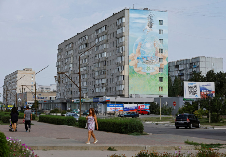 People walk along a street in Enerhodar