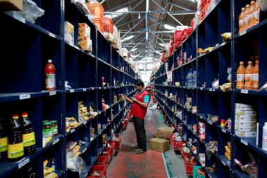 An employee scans a package for an order at a BigBasket warehouse on the outskirts of Mumbai