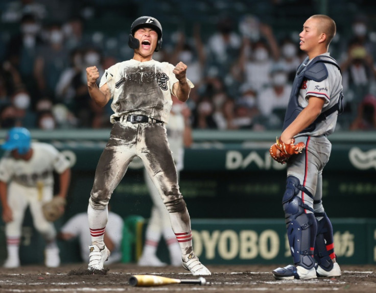 Taiki Komatsu, the captain of Ichinoseki Gakuin of Iwate prefecture, exults after scoring the winning run in the bottom of the 11th inning against Kyoto Kokusai