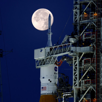 A full moon, known as the "Strawberry Moon" is shown with NASA’s next-generation moon rocket, the Space Launch System (SLS) Artemis 1, at the Kennedy Space Center in Cape Canaveral
