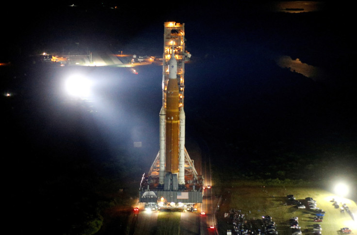 NASA's next-generation moon rocket, the Space Launch System rocket with its Orion crew capsule perched on top, leaves the Vehicle Assembly Building