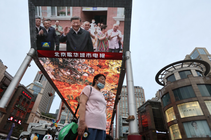 Screen shows news footage of Chinese President Xi Jinping visiting Xinjiang Uyghur Autonomous Region
