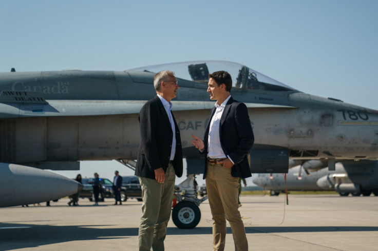 Canada's Prime Minister Justin Trudeau speaks with NATO Secretary General Jens Stoltenberg at CFB Cold Lake