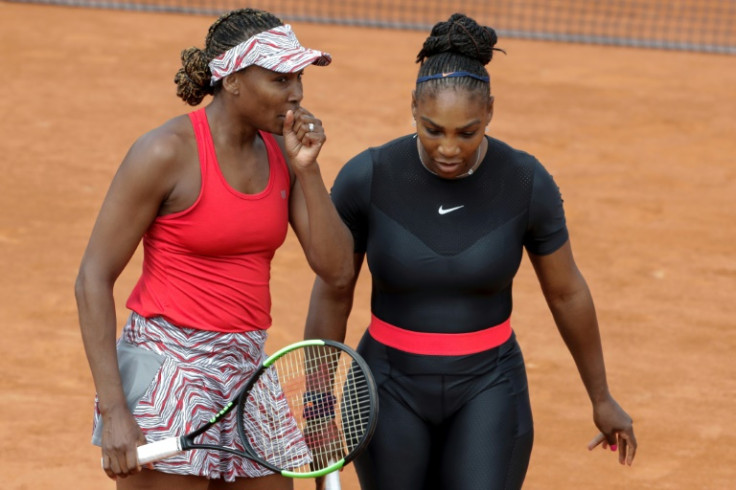 Sisters Venus (L) and Serena Williams will play doubles together at the US Open, their first pairing since 2018 -- they are seen here that year at the French Open in Paris