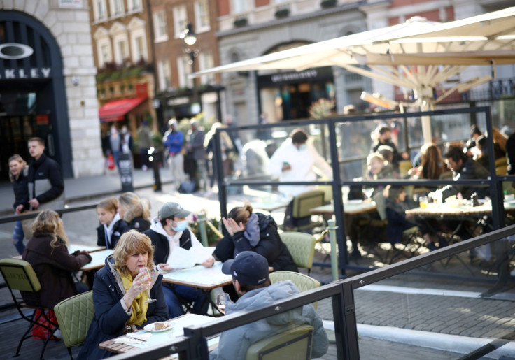 People sit at an outside restaurant area, as the coronavirus disease (COVID-19) restrictions ease, at Covent Garden in London,