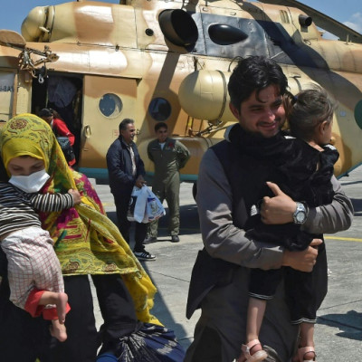 A Pakistani family leaves an army rescue helicopter in Swat after being rescued from a cut off valley