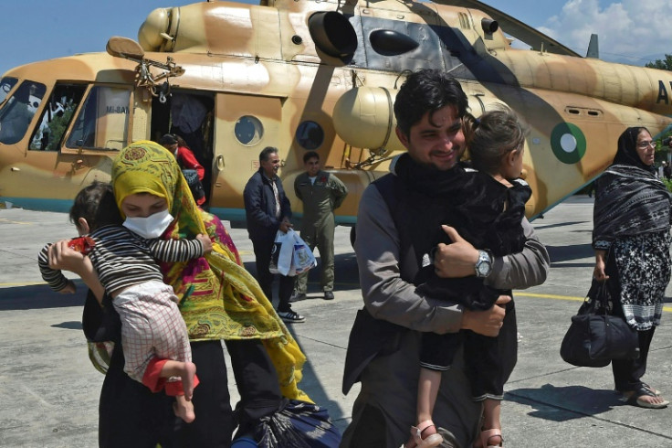 A Pakistani family leaves an army rescue helicopter in Swat after being rescued from a cut off valley