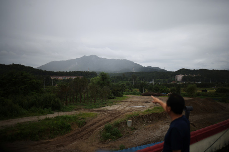 Lee Ung-su points out a training field where a joint live-fire drills are conducted near the demilitarized zone separating two Koreas, in Pocheon