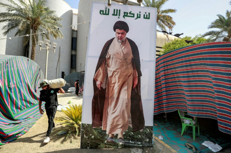 A Sadr supporter carries away items as they leave Baghdad's Green Zone